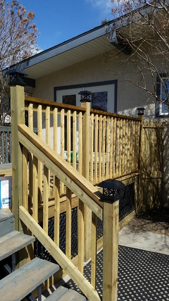 Wood deck railing and stairs with solar post cap lights